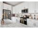 Modern kitchen with stainless steel appliances and white cabinets at 1245 Crooked Oak Rd, Charleston, SC 29492