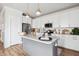 Modern kitchen featuring white cabinets, granite counters, and a large island at 1245 Crooked Oak Rd, Charleston, SC 29492