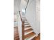 Elegant staircase with wooden railings and hardwood floors at 1245 Crooked Oak Rd, Charleston, SC 29492