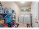 Bright laundry room with washer, dryer, and ample storage shelving at 130 Decatur Dr, Summerville, SC 29486