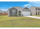 Gray siding house with white garage door, landscaping, and fenced yard at 133 Summit View Dr, Summerville, SC 29486