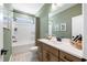 Bathroom with single vanity, tub shower combo, and green walls at 141 Winding Grove Lane Ln, Moncks Corner, SC 29461