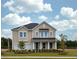 Two-story house with taupe siding, a metal roof, and a landscaped yard at 141 Winding Grove Lane Ln, Moncks Corner, SC 29461