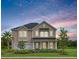 Two-story house with taupe siding, a metal roof, and a landscaped yard at 141 Winding Grove Lane Ln, Moncks Corner, SC 29461