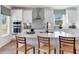 White kitchen with island, stainless steel appliances, and quartz countertops at 141 Winding Grove Lane Ln, Moncks Corner, SC 29461