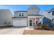 Two-story house with gray siding, white garage door, and landscaping at 166 Greenbelt Ct, Summerville, SC 29485