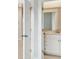 Open door reveals a bright bathroom with white cabinets and a quartz countertop at 199 Denham St, Summerville, SC 29486