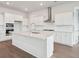 Modern kitchen with white cabinets, stainless steel appliances, and large island at 199 Denham St, Summerville, SC 29486