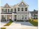 Two-story townhome with gray siding, front porch, and driveway at 211 Abercom Place Dr, Moncks Corner, SC 29461