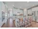 Modern kitchen featuring white cabinets, granite island, and stainless steel appliances at 216 Bumble Way, Summerville, SC 29485