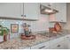 Kitchen features granite countertops and white cabinetry at 216 Bumble Way, Summerville, SC 29485