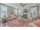 Bright living room features a fireplace, hardwood floors, and comfortable seating at 216 Bumble Way, Summerville, SC 29485