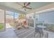 Relaxing screened porch with ceiling fan, seating area, and outdoor table at 216 Bumble Way, Summerville, SC 29485