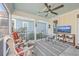 Screened porch with ceiling fan, comfortable seating, and a flat-screen TV at 216 Bumble Way, Summerville, SC 29485