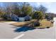 Aerial view of a gray house with a garage and a palm tree in the front yard at 228 Muirfield Pkwy, Charleston, SC 29414