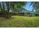 Green backyard with wooden fence and large trees at 2336 Parkstone Dr, Charleston, SC 29414