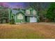 House exterior boasts green siding, gray roof and a white garage door at 2336 Parkstone Dr, Charleston, SC 29414