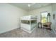 Charming bedroom with a bunk bed, window, and a small study area at 2910 Clearwater Dr, Mount Pleasant, SC 29466