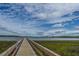 Wooden community dock extending to the water with calm marsh views at 2910 Clearwater Dr, Mount Pleasant, SC 29466