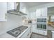 Modern kitchen with white cabinets, stainless steel appliances, and gas cooktop at 2910 Clearwater Dr, Mount Pleasant, SC 29466