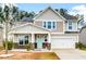 Two-story house with light gray siding, stone accents, and a two-car garage at 339 Spectrum Rd, Summerville, SC 29486