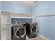Laundry room with built-in shelving and modern washer and dryer at 339 Spectrum Rd, Summerville, SC 29486