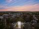 Aerial view of a residential area at sunset, highlighting a two-story white home at 341 Bridgetown Pass, Mount Pleasant, SC 29464