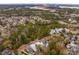Aerial view of a residential neighborhood with the home nestled among trees near a waterway at 341 Bridgetown Pass, Mount Pleasant, SC 29464