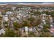 Aerial view showing a neighborhood, with a focus on a white two-story house near a pond at 341 Bridgetown Pass, Mount Pleasant, SC 29464