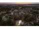 Aerial view of neighborhood at sunset, featuring a white two-story house near a pond at 341 Bridgetown Pass, Mount Pleasant, SC 29464