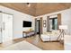 Bright bedroom with wood floors, featuring a sitting area and access to a private bathroom at 341 Bridgetown Pass, Mount Pleasant, SC 29464