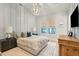 Serene bedroom with wood accent wall and large TV at 341 Bridgetown Pass, Mount Pleasant, SC 29464