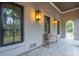 Covered porch with arched entryway and a bench at 341 Bridgetown Pass, Mount Pleasant, SC 29464
