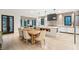 Modern kitchen and dining area with an island and wooden table at 341 Bridgetown Pass, Mount Pleasant, SC 29464