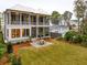 Two-story home with screened porch and a stone patio at 341 Bridgetown Pass, Mount Pleasant, SC 29464