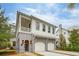Two-story home with white siding, gray accents, and a three-car garage at 341 Bridgetown Pass, Mount Pleasant, SC 29464