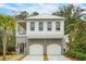 Two-story home with white siding, gray accents, and a three-car garage at 341 Bridgetown Pass, Mount Pleasant, SC 29464