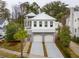 Two-story home with white siding, metal roof, and two-car garage at 341 Bridgetown Pass, Mount Pleasant, SC 29464