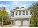 Two-story home with white siding, gray accents, and a three-car garage at 341 Bridgetown Pass, Mount Pleasant, SC 29464