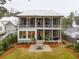 Two-story home with screened porch and a stone patio at 341 Bridgetown Pass, Mount Pleasant, SC 29464