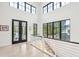 Bright hallway with French doors leading to balcony and large windows at 341 Bridgetown Pass, Mount Pleasant, SC 29464