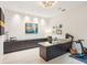 Bright home office features built-in cabinetry, large desk, and exercise bike at 341 Bridgetown Pass, Mount Pleasant, SC 29464