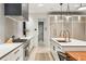 Modern kitchen with white cabinets, quartz countertops, and high-end appliances at 341 Bridgetown Pass, Mount Pleasant, SC 29464