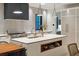 Modern kitchen island with white quartz countertops and a built-in shelf at 341 Bridgetown Pass, Mount Pleasant, SC 29464