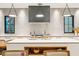 Modern kitchen with white cabinets, geometric backsplash and a large island at 341 Bridgetown Pass, Mount Pleasant, SC 29464