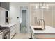 Modern kitchen with white cabinets, quartz countertops and a large island at 341 Bridgetown Pass, Mount Pleasant, SC 29464
