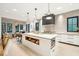 Modern kitchen with white cabinets, quartz countertops and a large island at 341 Bridgetown Pass, Mount Pleasant, SC 29464