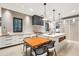 Modern kitchen with white cabinets, quartz countertops and a large island at 341 Bridgetown Pass, Mount Pleasant, SC 29464