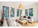 Cozy living room with light-colored sofa and large windows at 341 Bridgetown Pass, Mount Pleasant, SC 29464