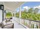 Relaxing outdoor porch with white railings and comfortable seating, overlooking lush greenery at 341 Bridgetown Pass, Mount Pleasant, SC 29464